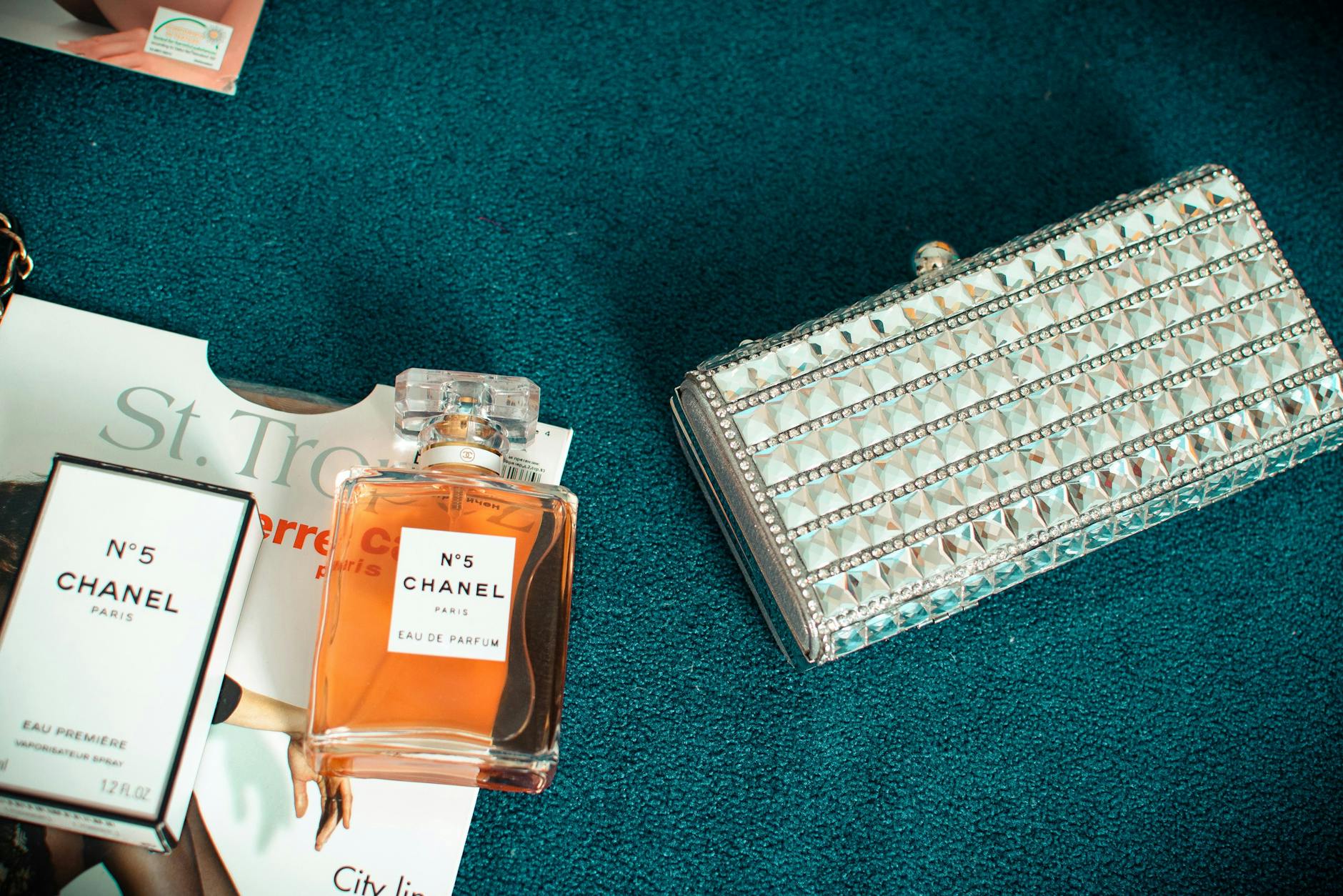silver long wallet on teal textile